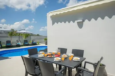 a table with food and drinks on a patio at b&m villas in Metókhion Sirilíou