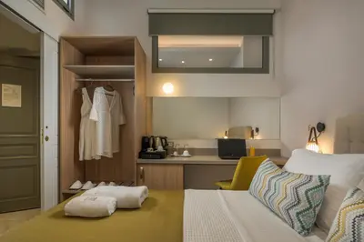 a small room with a bed and a kitchen at Plaza 1866 Superior City Rooms in Chania Town