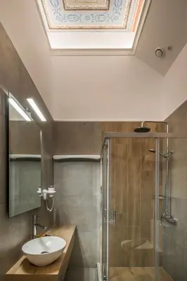 a bathroom with a sink and a shower at Plaza 1866 Superior City Rooms in Chania Town