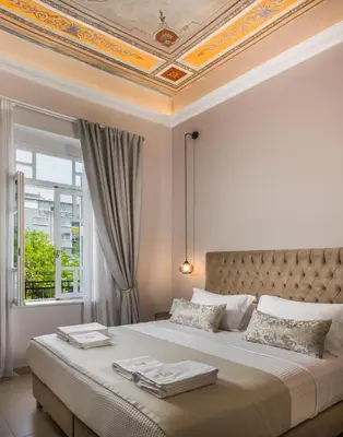 a bedroom with a large bed with a coffered ceiling at Plaza 1866 Superior City Rooms in Chania Town
