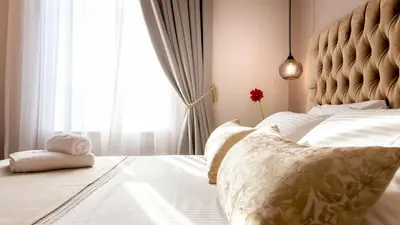 a bedroom with a bed with a large window at Plaza 1866 Superior City Rooms in Chania Town