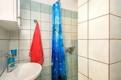a bathroom with a sink and a shower at Golden Beach Hill Apartments in Kato Daratso