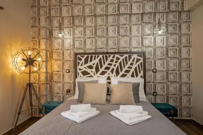 a bedroom with a bed with two towels on it at Olvini Villa in Galatás