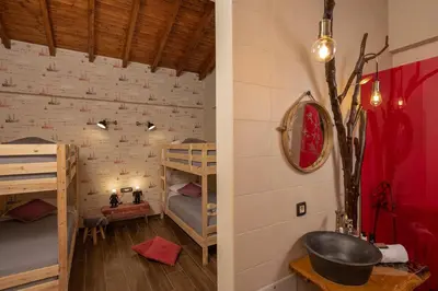 a room with two bunk beds and a sink at Olvini Villa in Galatás