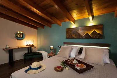a bedroom with a bed with a tray of food on it at Olvini Villa in Galatás