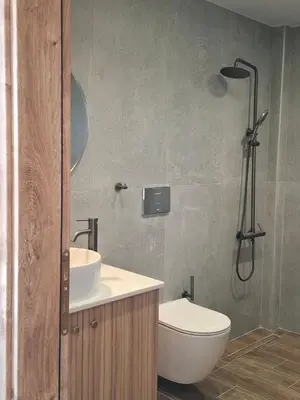 a bathroom with a shower and a toilet and a sink at Grammeno Seaside Studios in Palaiochóra