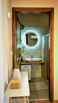 a bathroom with a sink and a mirror at Villa Rosemari, Anatoli Apartment in Afráta