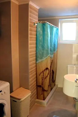 a bathroom with a shower curtain and a sink at Chania City Home in Chania Town