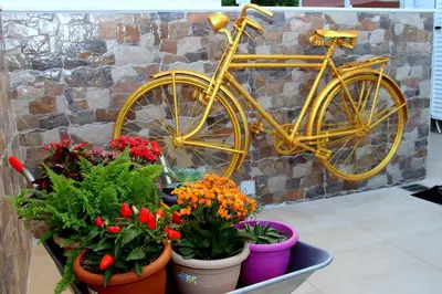 a yellow bike parked next to a bunch of flowers at Chania City Home in Chania Town