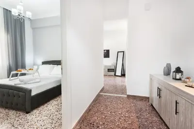 a bedroom with a bed and a table in a room at Anemelia in Chania Town