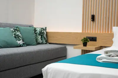 a living room with a couch and a bed at Lignum Suites Chania in Chania Town