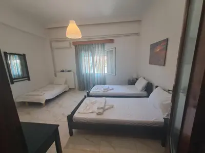 a room with two beds and a couch in it at Chania Dream Home in Chania Town