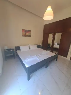 a bedroom with a large bed with white sheets at Chania Dream Home in Chania Town