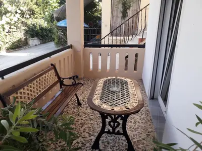 a bench sitting on a porch next to a window at Chania Dream Home in Chania Town