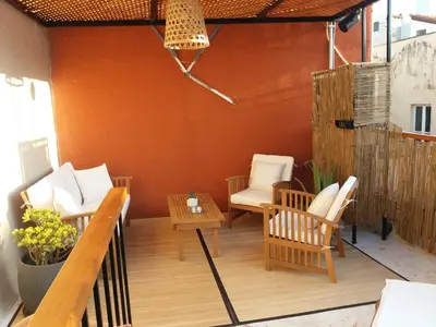 a patio with two chairs and a table on a deck at Fivos Residence in Chania Town