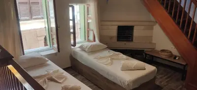 two beds in a room with two windows at Fivos Residence in Chania Town