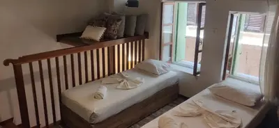 two beds in a room with two windows at Fivos Residence in Chania Town