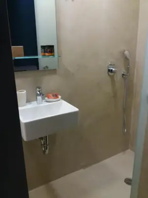 a bathroom with a white sink and a shower at Fivos Residence in Chania Town