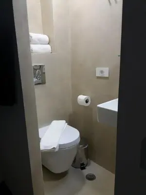a bathroom with a toilet and a sink and towels at Fivos Residence in Chania Town