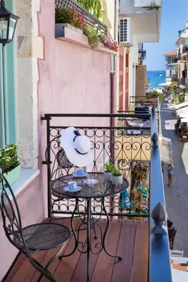 a table and chairs on a balcony with a view of the ocean at Iosifinas Boutique House in Chania Town