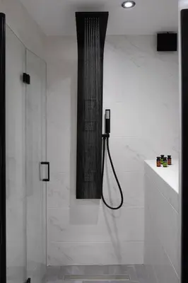 a white bathroom with a shower and a glass door at Iosifinas Boutique House in Chania Town