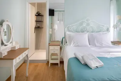 a bedroom with a bed and a vanity and a mirror at Iosifinas Boutique House in Chania Town