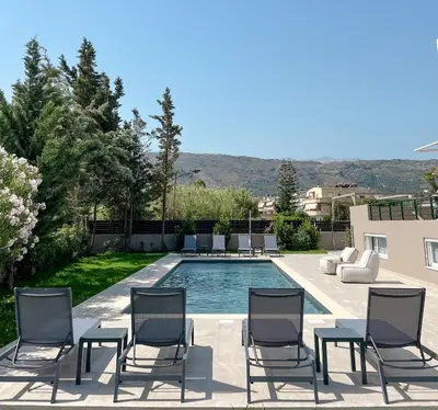 a patio with chairs and a swimming pool at Sweven Villa Private Pool & Absolute Privacy , Stunning Sunsets in Souda