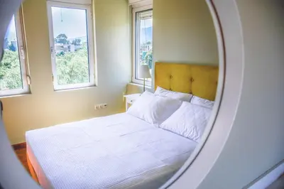 a bedroom with a white bed and two windows at Sweven Villa Private Pool & Absolute Privacy , Stunning Sunsets in Souda