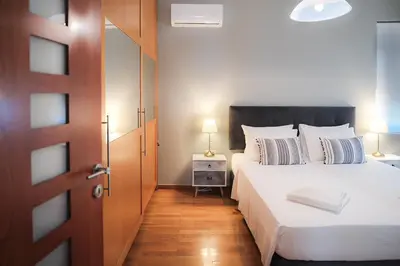 a bedroom with two beds with a door open at Sweven Villa Private Pool & Absolute Privacy , Stunning Sunsets in Souda