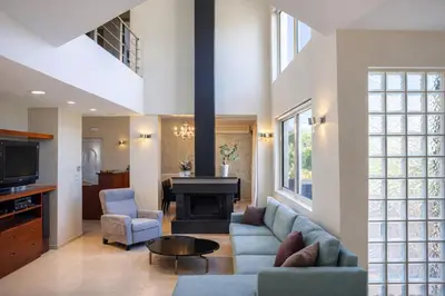 a living room with a couch and a fireplace at Sweven Villa Private Pool & Absolute Privacy , Stunning Sunsets in Souda