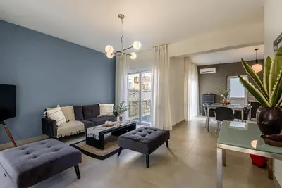 a living room with a couch and a table at Azure Beach Villas in Kissamos