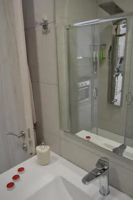 a bathroom with a sink and a mirror at Paraskevi's Apartments in Kissamos