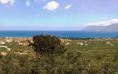 a view of a town with the ocean in the background at OLIVE BREEZE in Kissamos