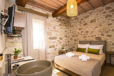 a bathroom with a bed and a tub in a room at Kamartsos Villa 2 in Áyios Yeóryios