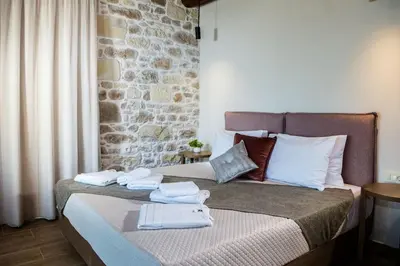 a bedroom with a bed with towels on it at Kamartsos Villa 2 in Áyios Yeóryios