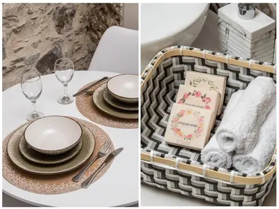 a table with plates and napkins and a basket of dishes at Stairs Homes & Suites in Kamária