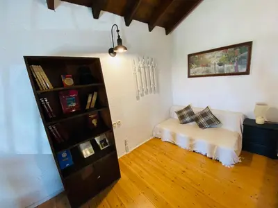 a room with a bed and a book shelf at The Green Home in Afráta