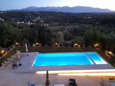 a swimming pool with a view of the mountains at Raphael Evangellos Villa in Gavalochori