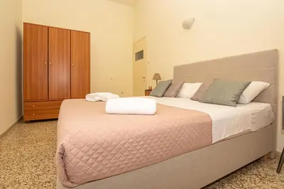 a bedroom with a large bed and a wooden cabinet at Veranda house in Chania Town