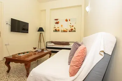 a living room with a couch and a table at Veranda house in Chania Town