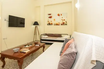 a living room with a bed and a coffee table at Veranda house in Chania Town