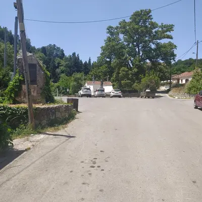 an empty street with cars parked on the road at Therisso Rooms in Thérison