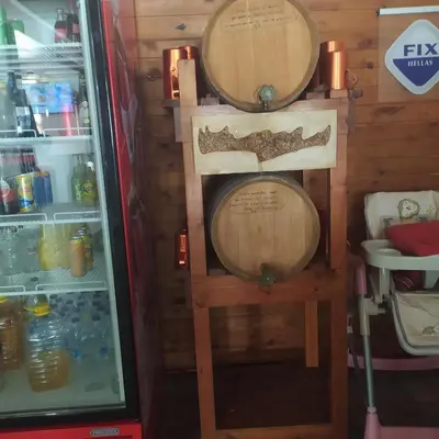 a refrigerator with two wine barrels in it at Therisso Rooms in Thérison