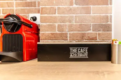 a red appliance sitting on a counter next to a brick wall at MOS Luxury City Suites - The Loft in Chania Town