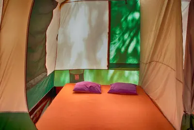a room with two purple pillows in a tent at Camping Nopigia in Kissamos