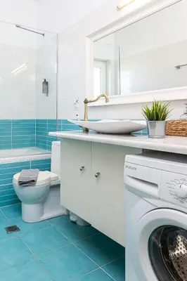 a bathroom with a washing machine and a sink at Villa PENELOPE in Galatás