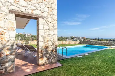 an external view of a villa with a swimming pool at Villa PENELOPE in Galatás