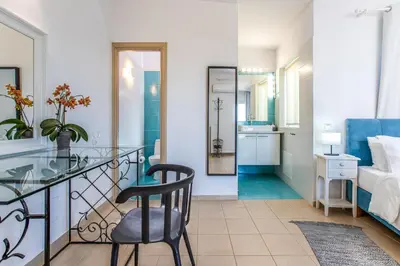 a bedroom with a glass table and a chair at Villa PENELOPE in Galatás