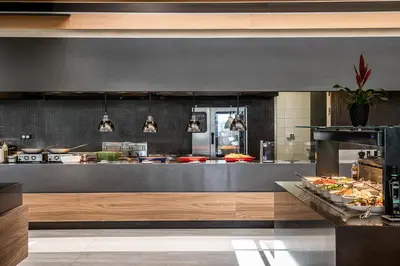 a restaurant kitchen with a buffet of food at Euphoria Resort - All Inclusive in Kolymvari