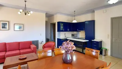 a living room with a table and a red couch at Villa 